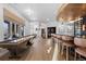 Expansive entertainment space with a shuffleboard table, custom bar area, and comfortable seating, perfect for hosting gatherings at 948 Buffalo Ridge Rd, Castle Pines, CO 80108