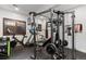 Functional home gym features a weight machine, spin bike, treadmill and rubber flooring at 948 Buffalo Ridge Rd, Castle Pines, CO 80108