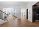 Elegant hallway with arched doorways leading to the living room, kitchen, and a stairway to the left at 948 Buffalo Ridge Rd, Castle Pines, CO 80108
