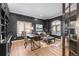 Stylish home office with dark walls, hardwood floors, a desk, and a cozy seating area at 948 Buffalo Ridge Rd, Castle Pines, CO 80108
