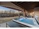 Covered outdoor hot tub with scenic views, stone columns and seating area for outdoor relaxation at 948 Buffalo Ridge Rd, Castle Pines, CO 80108