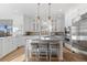 Spacious kitchen with a large center island, white cabinets, and stainless steel appliances at 948 Buffalo Ridge Rd, Castle Pines, CO 80108
