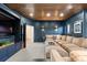 Spacious living room features a large sectional sofa, custom cabinetry, a wooden ceiling and recessed lighting at 948 Buffalo Ridge Rd, Castle Pines, CO 80108
