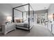 Serene main bedroom featuring a four-poster bed, soft lighting, and balcony access with views of the outdoors at 948 Buffalo Ridge Rd, Castle Pines, CO 80108