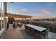 Expansive outdoor patio with a dining table, comfortable seating, a pergola, and a scenic view at sunset at 948 Buffalo Ridge Rd, Castle Pines, CO 80108