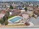 Overhead view of community pool with parking and luxurious homes in a desirable neighborhood at 948 Buffalo Ridge Rd, Castle Pines, CO 80108
