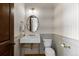 Chic powder room with a unique sink, patterned wallpaper, and stylish fixtures, offering a touch of elegance at 948 Buffalo Ridge Rd, Castle Pines, CO 80108