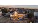 Spacious home with an expansive backyard, featuring a deck, patio, hot tub, and lush landscaping, ideal for outdoor enjoyment at 948 Buffalo Ridge Rd, Castle Pines, CO 80108