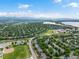 An aerial view of a neighborhood with mature trees, a school, and a large lake in the background at 5660 S Eaton St, Littleton, CO 80123