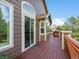 Spacious wooden back deck with brown siding and views of trees and blue skies at 5660 S Eaton St, Littleton, CO 80123