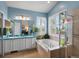 Bright blue bathroom with double sinks, tub, and separate shower at 5660 S Eaton St, Littleton, CO 80123