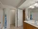 Bathroom with vanity, tile flooring, and shower/tub combo with blue shower curtain at 5660 S Eaton St, Littleton, CO 80123