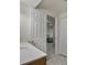 Bright bathroom featuring a white vanity, tile floors, and a door leading to the bedroom at 5660 S Eaton St, Littleton, CO 80123