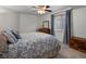 Cozy bedroom with a floral comforter, wooden dresser, and natural light from a window at 5660 S Eaton St, Littleton, CO 80123