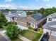 An eye-level aerial of a home featuring solar panels, a three-car garage, and manicured landscaping at 5660 S Eaton St, Littleton, CO 80123
