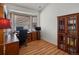 Bright home office featuring a wooden desk, blinds, and built-in shelving at 5660 S Eaton St, Littleton, CO 80123