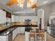Well-lit kitchen with stainless steel appliances and an island with barstool seating at 5660 S Eaton St, Littleton, CO 80123