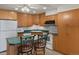 Well-lit kitchen featuring wood cabinets, green countertops and a charming breakfast bar at 5660 S Eaton St, Littleton, CO 80123