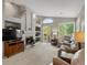 Inviting living room featuring a fireplace, built-in shelving, and access to the balcony at 5660 S Eaton St, Littleton, CO 80123