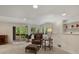 Bright living room with neutral carpet, a decorative chair set, and a sliding door to a deck at 5660 S Eaton St, Littleton, CO 80123
