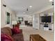 Spacious living room features neutral carpet, large TV, and comfortable furniture at 5660 S Eaton St, Littleton, CO 80123