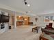Open-concept living room with breakfast bar, TV, and comfortable furniture at 5660 S Eaton St, Littleton, CO 80123
