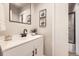 Modern bathroom with sleek vanity, matte black faucet, and tiled shower at 3750 S Fairplay Way, Aurora, CO 80014