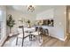Dining room showcasing a stylish table set with an elegant rug, and direct view into the kitchen at 3750 S Fairplay Way, Aurora, CO 80014