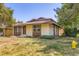 Exterior view of a home with a manicured lawn and mature landscaping at 3750 S Fairplay Way, Aurora, CO 80014
