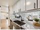 Modern kitchen featuring sleek countertops and a view to the cozy living room at 3750 S Fairplay Way, Aurora, CO 80014