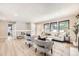 Spacious living room with ample natural light and stylish seating arrangement showcases an inviting living space at 3750 S Fairplay Way, Aurora, CO 80014