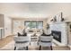 Bright living room with large windows, fireplace, and neutral decor creates a warm and welcoming atmosphere at 3750 S Fairplay Way, Aurora, CO 80014
