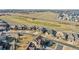 Wide aerial view showcasing the community, golf course, and well-spaced homes at 27655 E Moraine Dr, Aurora, CO 80016