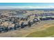 An aerial view of a beautiful community with lush landscaping, a serene lake, and well-maintained homes at 27655 E Moraine Dr, Aurora, CO 80016