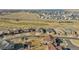 Expansive aerial view of the community with a golf course and plenty of surrounding open space at 27655 E Moraine Dr, Aurora, CO 80016