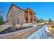 Backyard with stone retaining wall and upper level covered patio area at 27655 E Moraine Dr, Aurora, CO 80016
