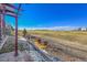 Landscaped backyard featuring a fire pit and views of a golf course at 27655 E Moraine Dr, Aurora, CO 80016