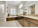 Elegant bathroom with double sink vanity, soaking tub, and modern fixtures at 27655 E Moraine Dr, Aurora, CO 80016