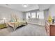 Bright bedroom features plush carpeting, large windows, and neutral decor at 27655 E Moraine Dr, Aurora, CO 80016