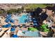 Aerial view of the community pool area, with ample seating, umbrellas, and a splash pad at 27655 E Moraine Dr, Aurora, CO 80016