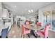 Open concept dining area with elegant lighting, hardwood flooring and views of the kitchen and living areas at 27655 E Moraine Dr, Aurora, CO 80016
