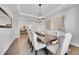 Formal dining room boasts a large table, upholstered chairs, elegant lighting, and stylish decor at 27655 E Moraine Dr, Aurora, CO 80016