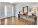 Elegant foyer featuring hardwood floors, a decorative console table, and a bright white front door at 27655 E Moraine Dr, Aurora, CO 80016