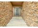 Charming front entrance with stone accents, a welcoming door with a wreath, and a well-maintained walkway at 27655 E Moraine Dr, Aurora, CO 80016
