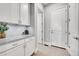 Hallway features white cabinets, granite countertops, and neutral tile flooring at 27655 E Moraine Dr, Aurora, CO 80016