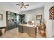 Home office featuring custom bookshelves, hardwood floors, and ample desk space at 27655 E Moraine Dr, Aurora, CO 80016