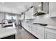 Bright, open kitchen with white cabinetry, stainless steel appliances, and a view to the outdoors at 27655 E Moraine Dr, Aurora, CO 80016