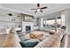 Cozy living room featuring a fireplace, built-in shelves, and comfortable seating with backyard views at 27655 E Moraine Dr, Aurora, CO 80016