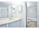 Bright bathroom featuring a shower-tub combo, a single sink, and wood-look flooring at 7185 S Gaylord St # A, Littleton, CO 80122