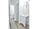 Stylish bathroom with modern vanity, cabinet, and wood-look flooring, offering ample storage at 7185 S Gaylord St # A, Littleton, CO 80122